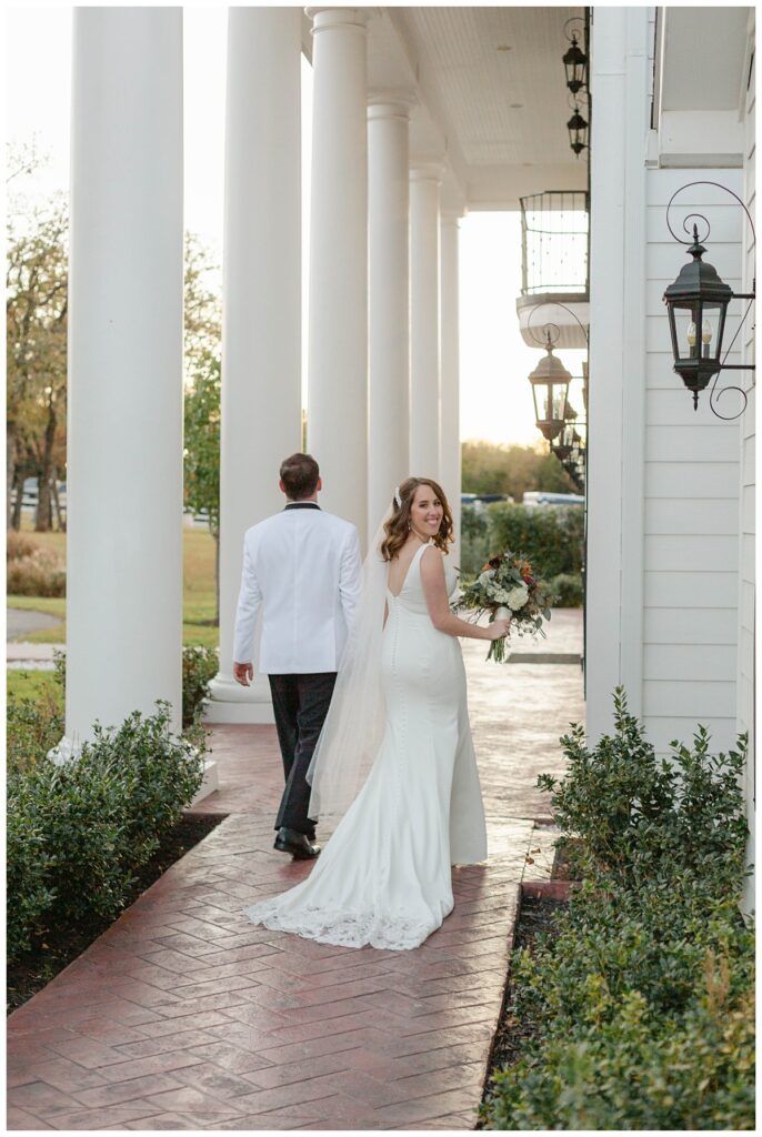 BW bride and groom walking away after ceremony and kissing The Springs in Weatherford