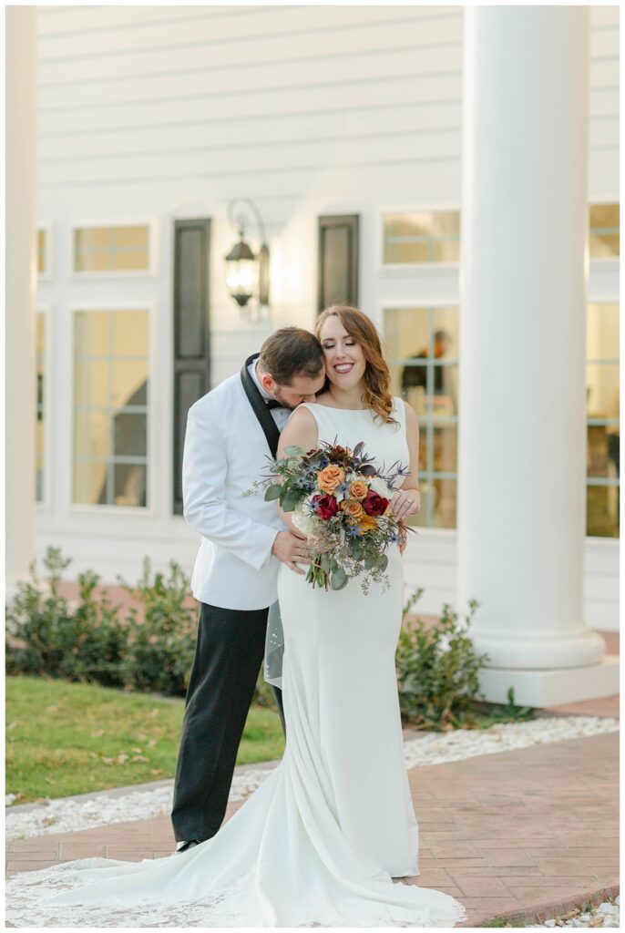 groom kissing bride on shoulder at The Springs in Weatherford Texas wedding