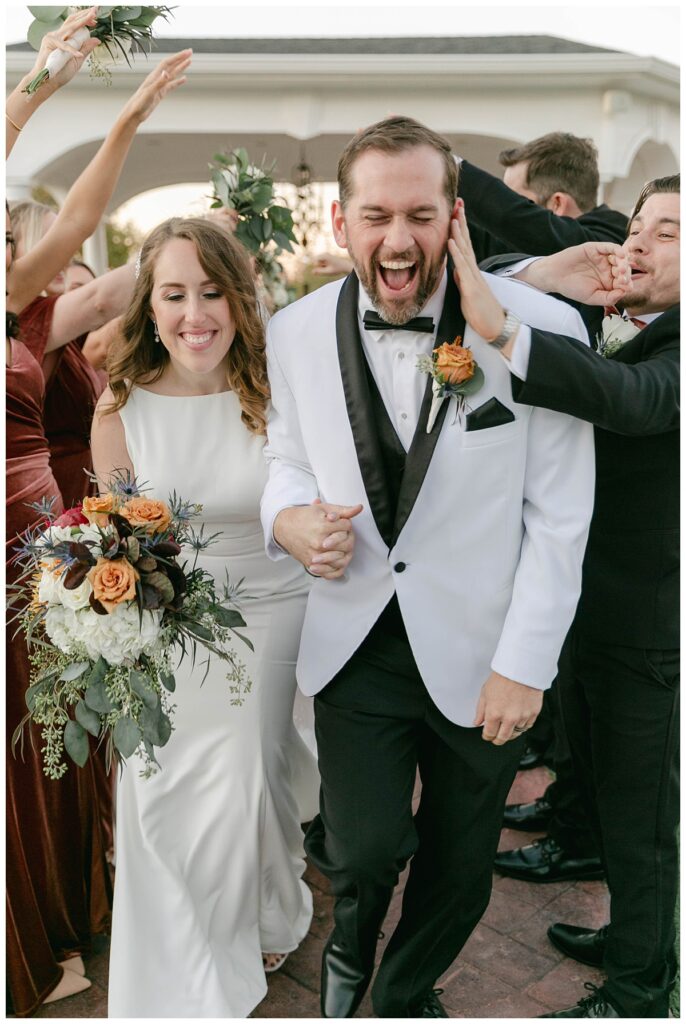 bridal party making tunnel for bride and groom